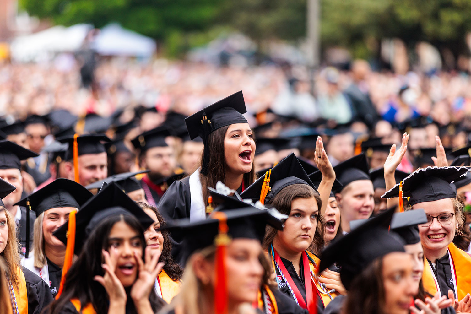 Students loudly cheering from their seats during Commencement