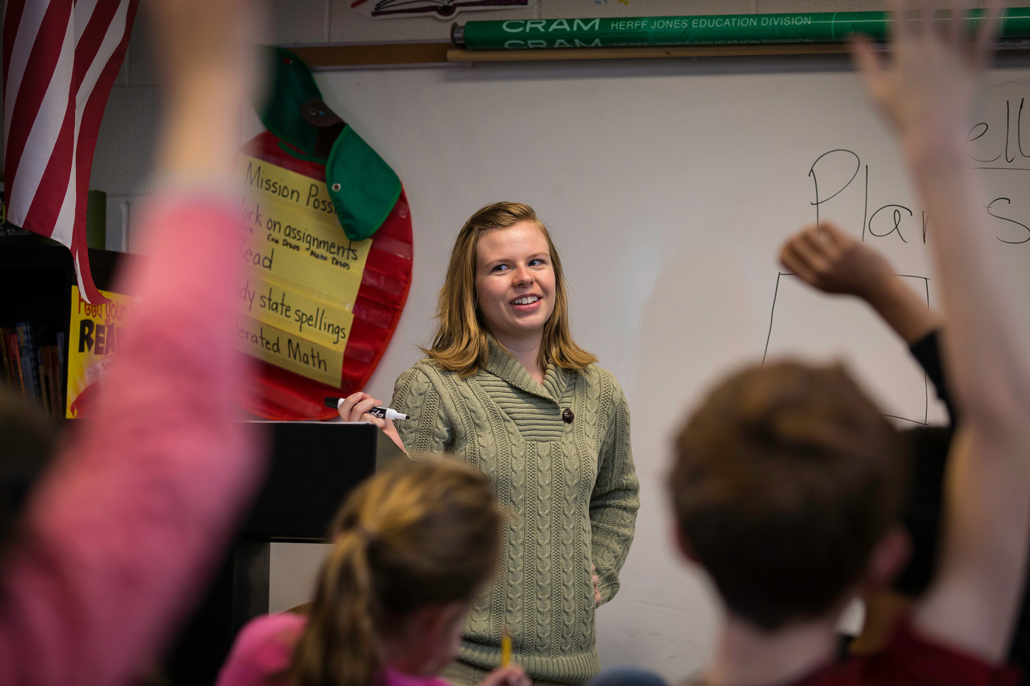 woman in front of classroom of children