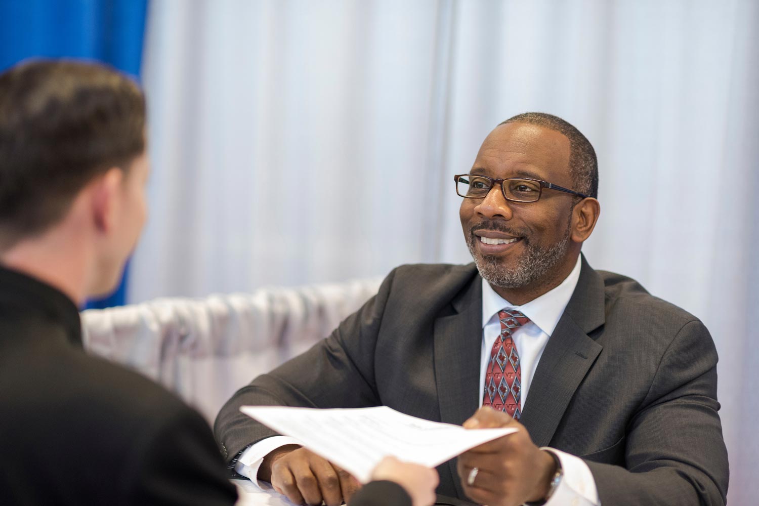 two males talking during an educational career fair