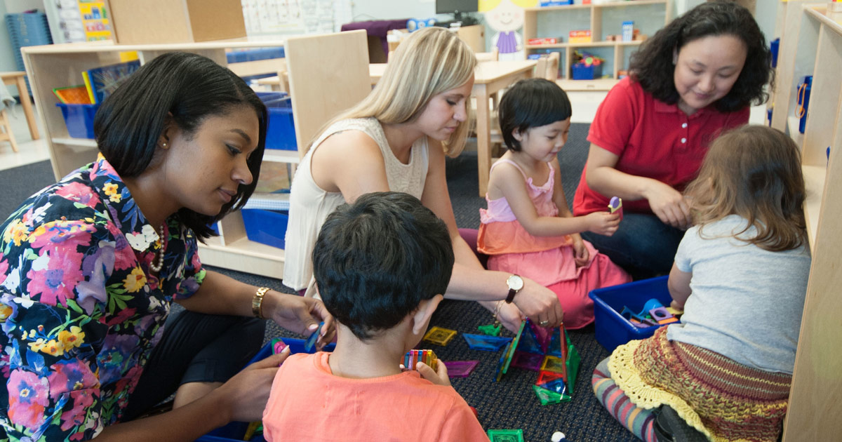 young children in classroom with student teachers