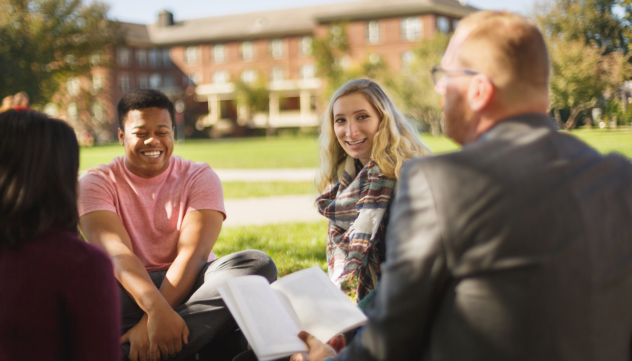 students discussing work on campus