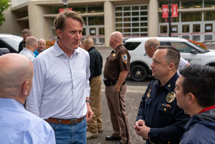 Gov. Glen Youngkin talks with Rob Hoover, vice president of finance and administration, Eric Plummer, Radford University chief of police, and Peter McCann, director of emergency management.