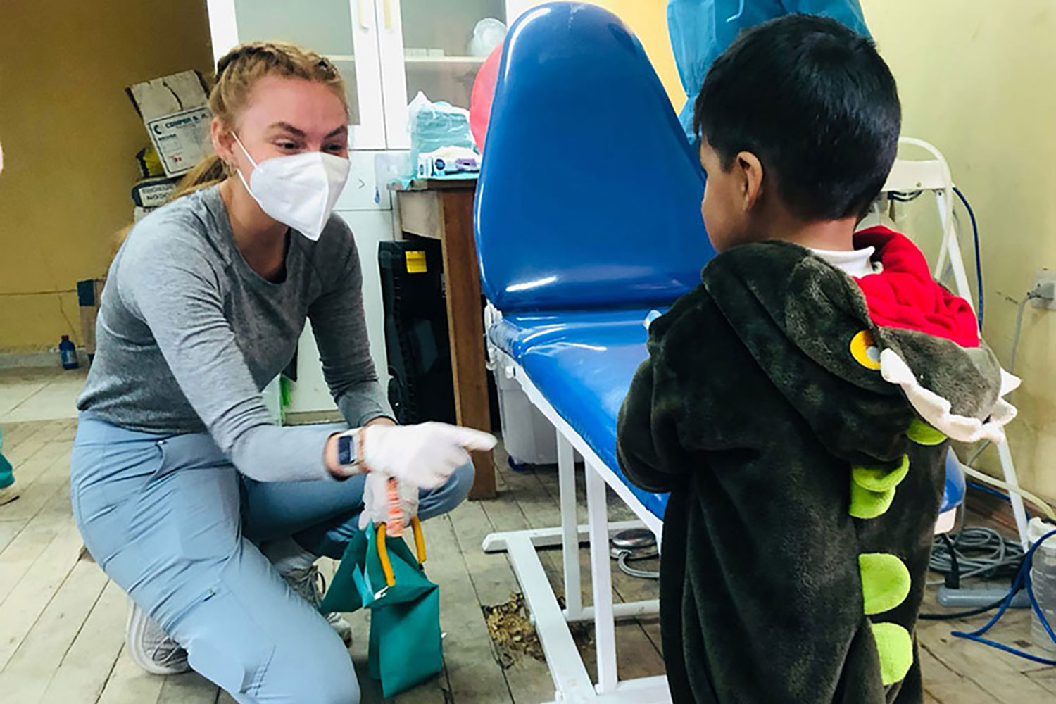 A Radford University student working with a child during a service learning trip in Peru. 