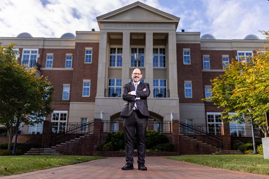 A professor stands outside Radford University's Davis College of Business and Economics