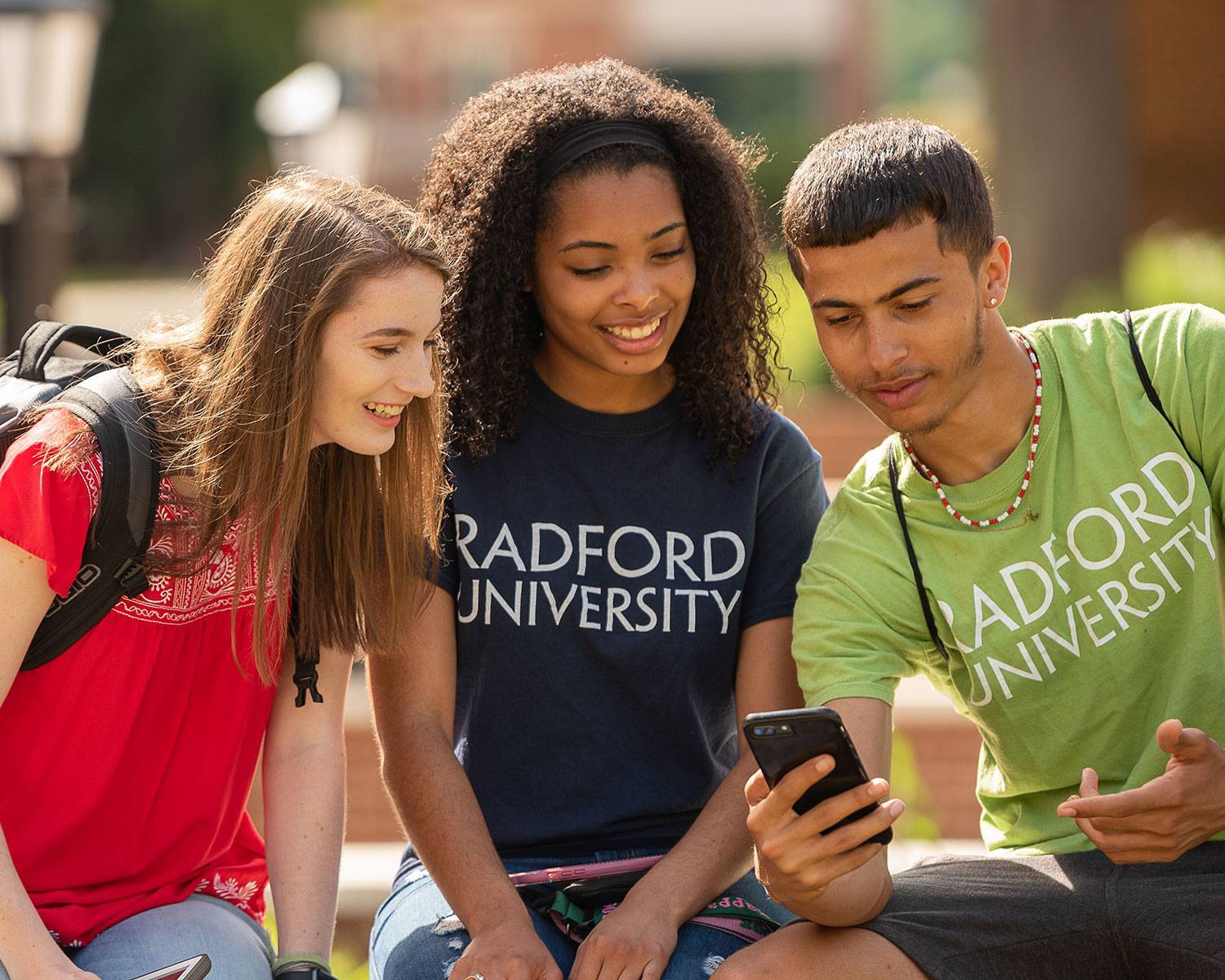 Student showing classmates how to use Mobile ID