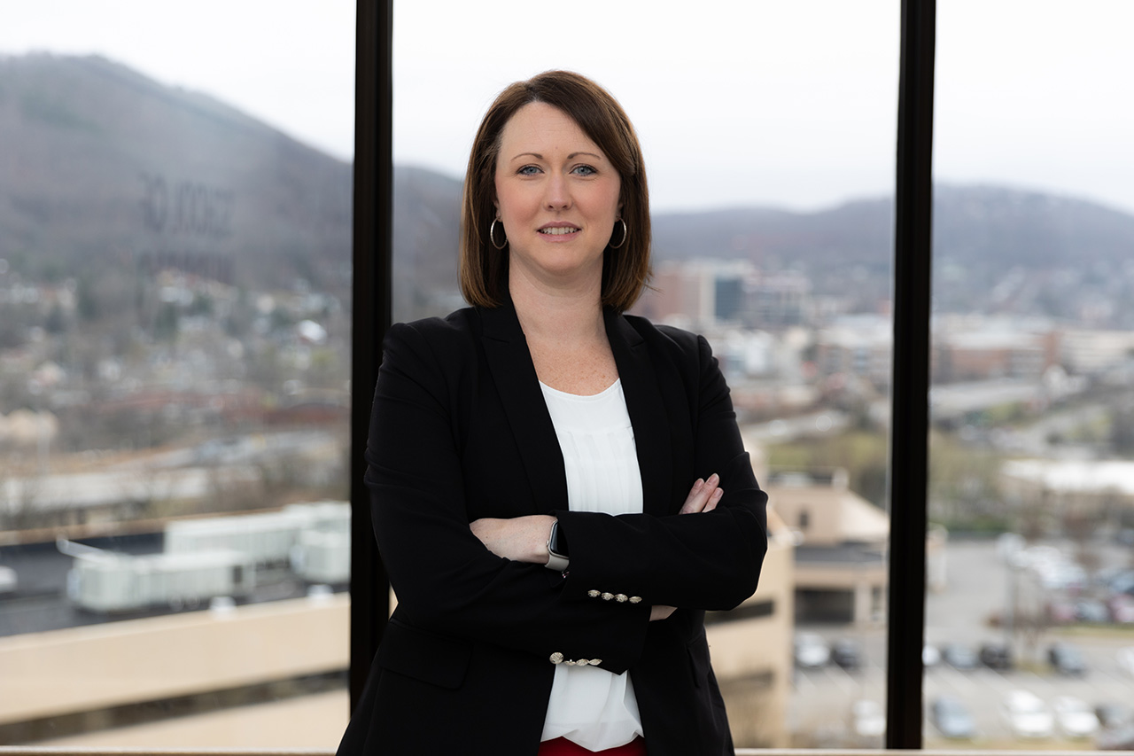 Jessica Nichols, in a blazer facing the camera and smiling