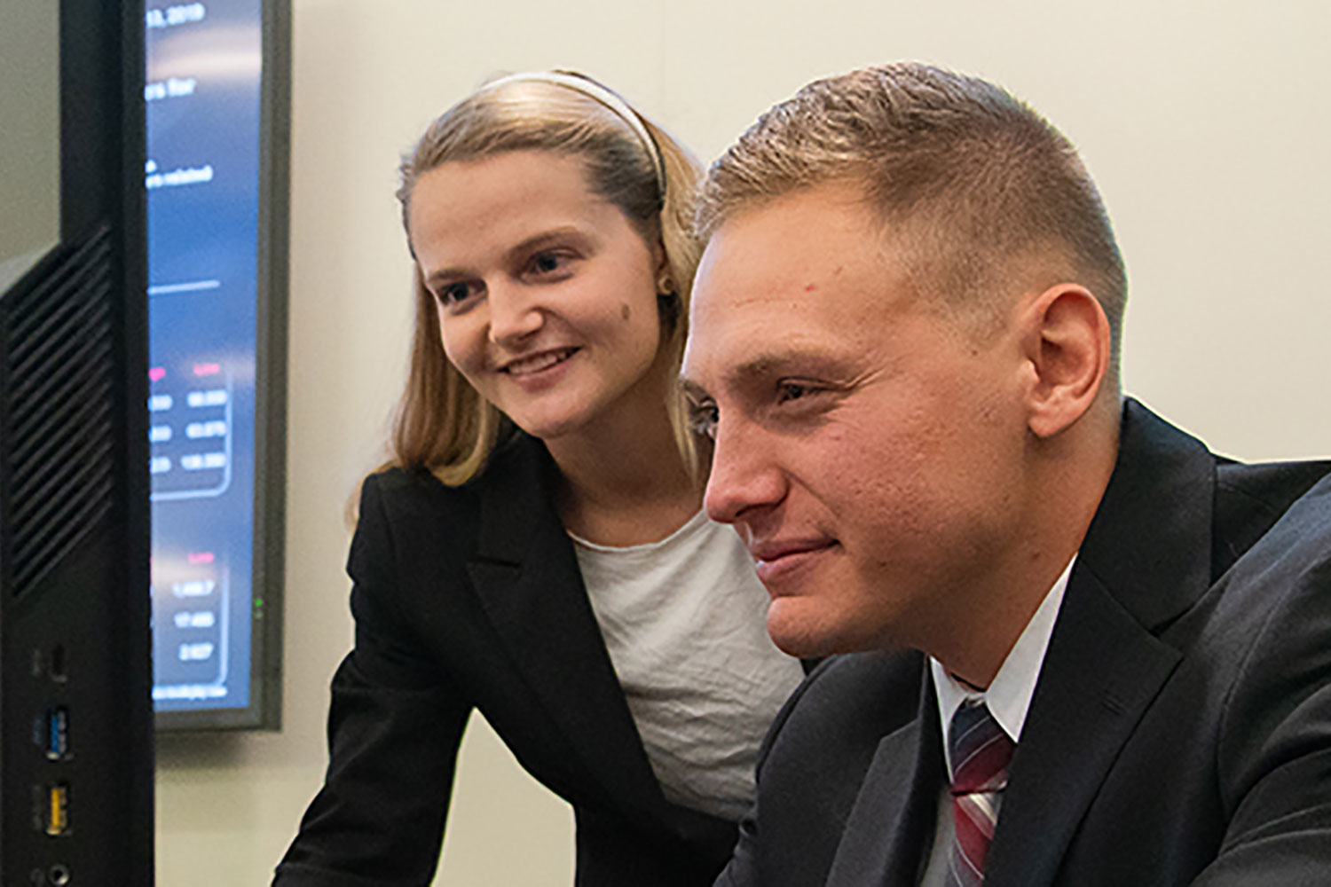 two students looking at a laptop