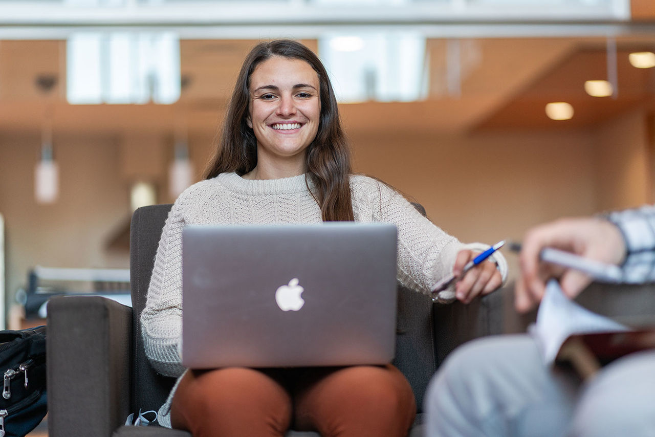 student sitting and smiling