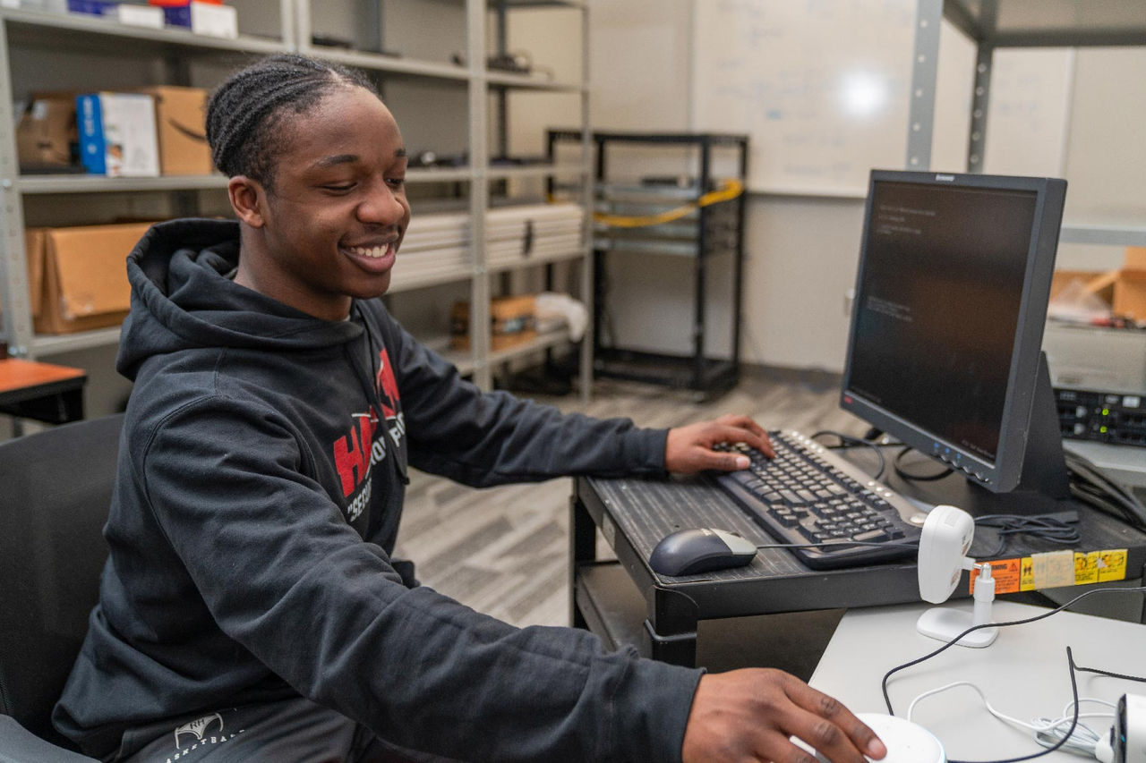 student at a computer desk