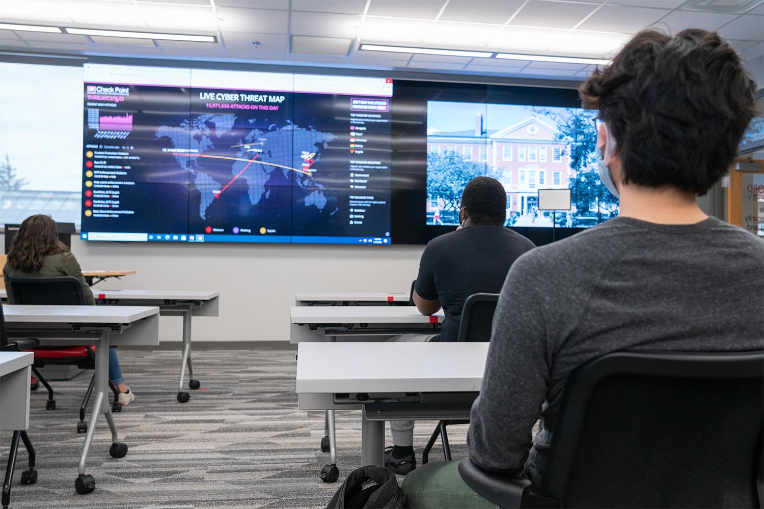 the back of students facing a screen