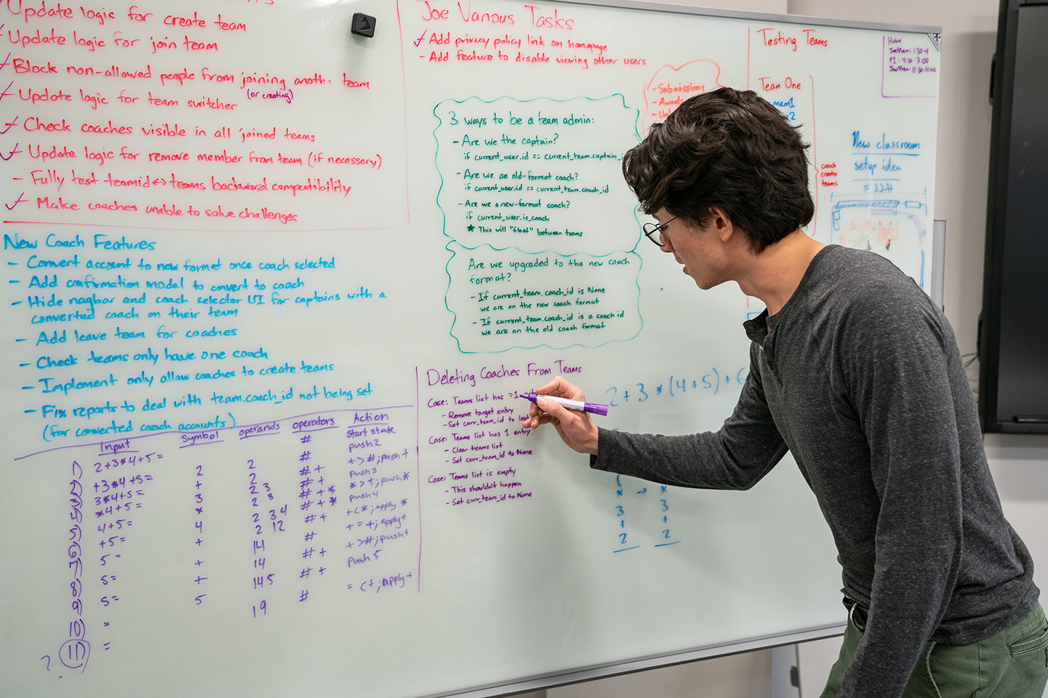 person writing on a whiteboard