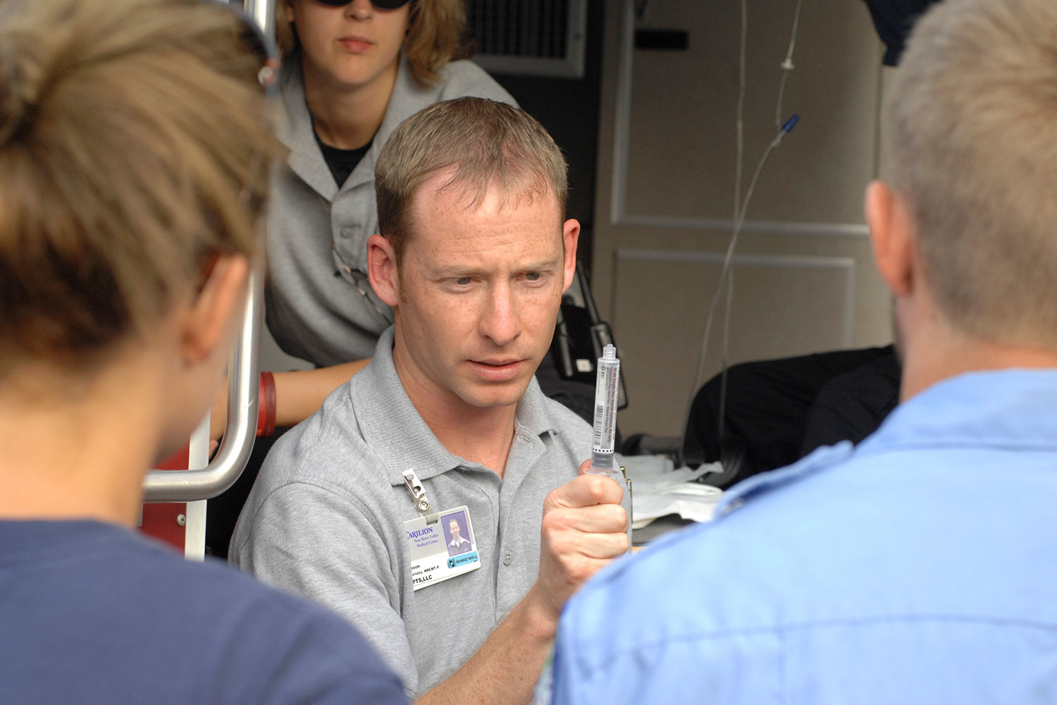 a close up of a man holding a syringe