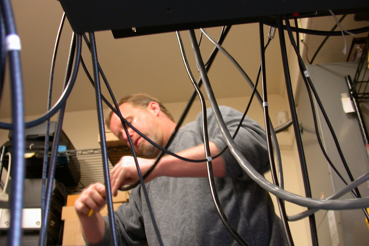 a man inspecting wires