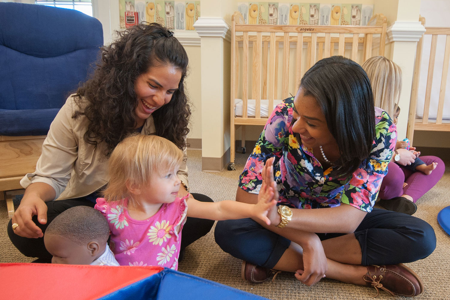 teachers interacting with toddlers 